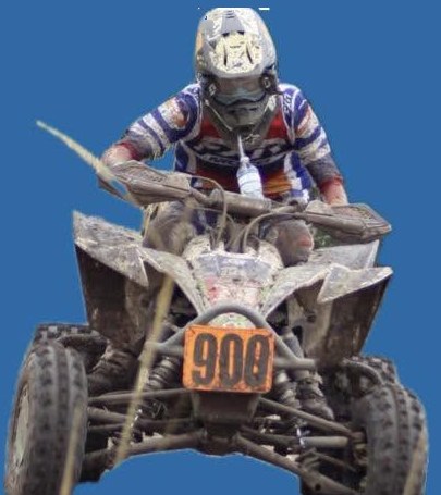 Chance airborne over a rise on a mud-covered quad, plate 908